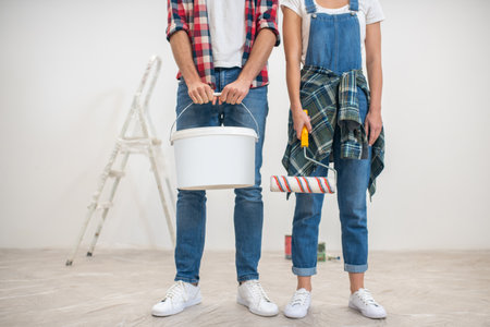 Wall painting. Close up picture of two people standing near the wallの写真素材
