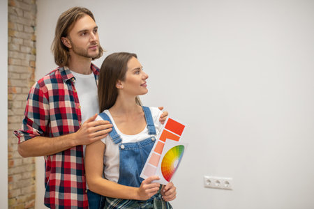 Choice. Young couple discussng the wall color in a new houseの写真素材