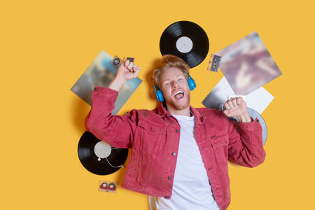 Music lover. Ginger smiling man lying near the records and feeling goodの写真素材