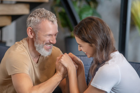 Happy family. Bearded man and young woman hugging and enjoying being together