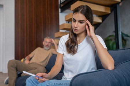 Pregnancy. Young dark-haired woman looking stressed while looking at the pregnancy testの写真素材
