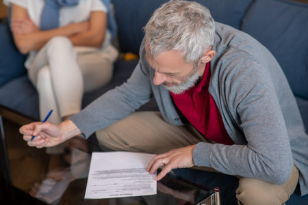 Petition for divorce. An elderly man filling a petition for divorceの写真素材