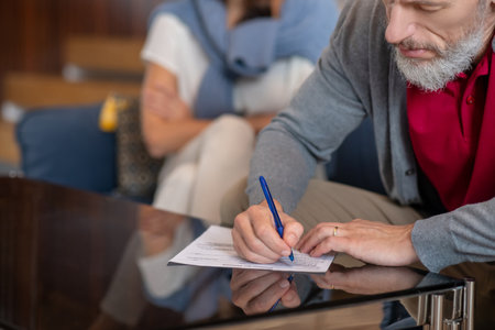 End of marriage. A bearded man writing a petition for divorceの写真素材