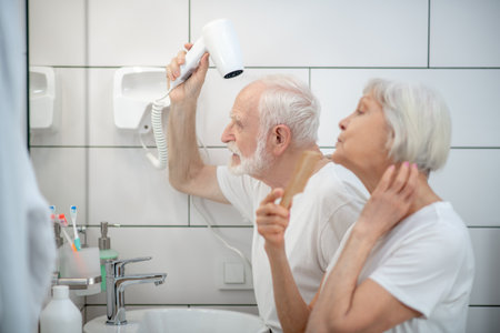 Morning together. Elderly couple having their morning routine togetherの写真素材