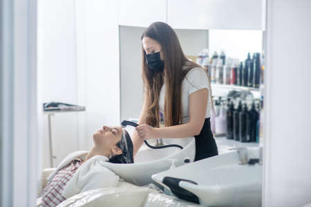 Hair salon. Woman spending time in a hair salon and looking relaxedの写真素材