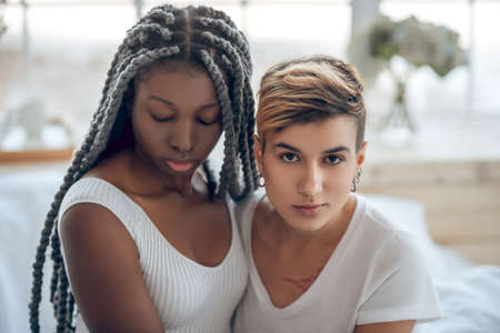Couple. Picture of a same sex couple sitting next to each otherの写真素材