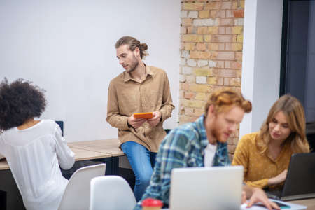 Teamwork.Team of young professionals working in the office together and looking involvedの写真素材