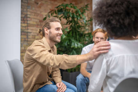 Psychological support. Group members supporting each other and looking friendly