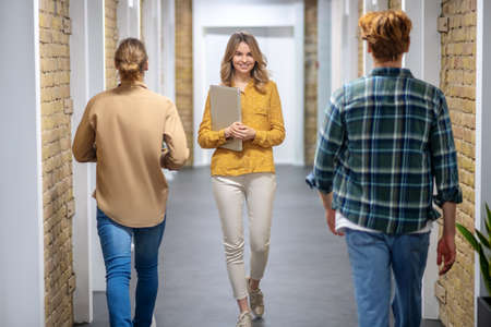 In the office. Colleagues meeting in the corridor of the business center