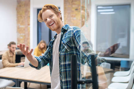 Ginger guy. Smiling ginger guy in a checkered shirt looking happy