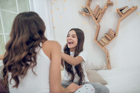 Enthusiastic girl and woman with back to cameraの写真素材