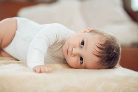 Calm little baby lying on his stomach