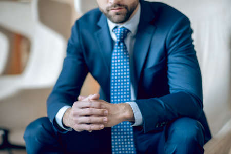 Young bearded man in a nice blue suit and tieの写真素材