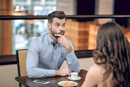 Man and woman having a blind date and looking disappointedの写真素材
