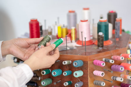 Female hands holding two skeins of thread