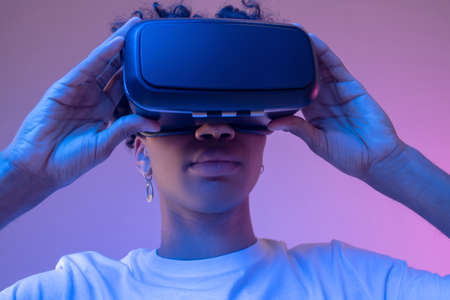 African american young guy wearing vr glasses and looking entertained