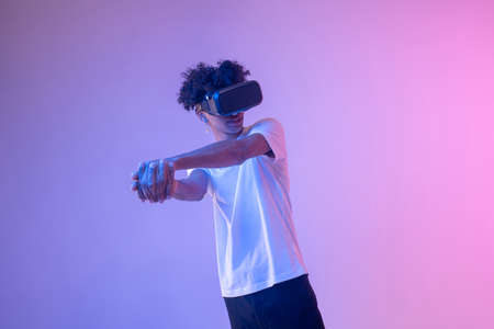 African american young guy in vr glasses enjoying the gameの写真素材