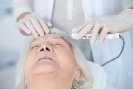 Mature woman having face beauty treatment in a beauty clinic