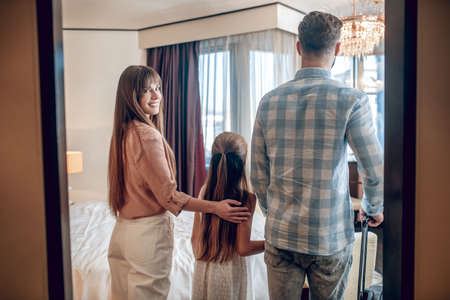 Family arrived to the hotel and entering the roomの写真素材