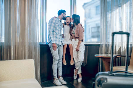 Young cute family arrived to the hotel on vacationの写真素材