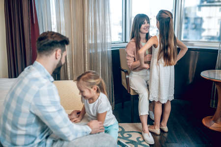 Young family in the room in the hotel getting ready for breakfastの写真素材