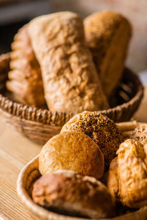 Appetizing fresh buns in wicker basket