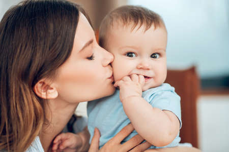 Tender loving young mother kissing her babyの写真素材