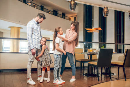 Two girls and their parents in the hotelの写真素材