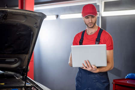 Man looking at laptop holding in hands