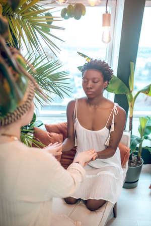 Dark-skinned woman visiting a doctor of alternative medicineの写真素材