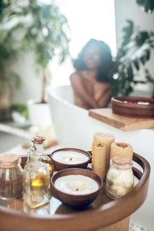 Dark-skinned woman relaxing in a bath and washing her bodyの写真素材