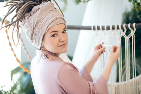 Young woman in a headwear looking inspired
