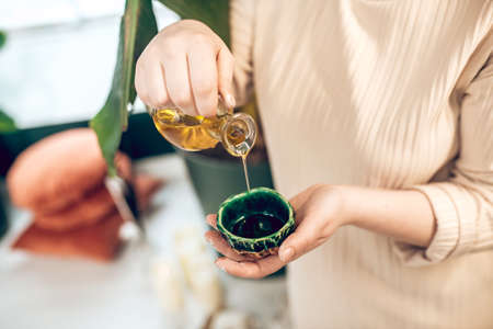 Young woman preparing naural beauty products and looking busyの写真素材