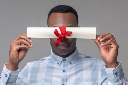 African american holding scroll at face levelの写真素材