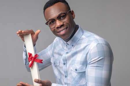 Happy dark skinned man with important scroll