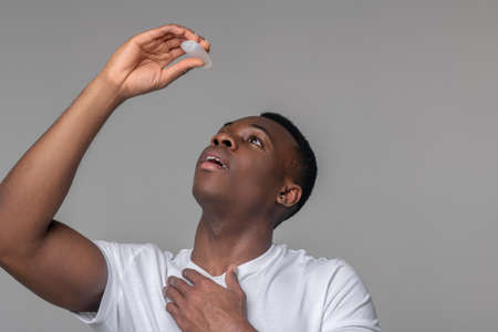 Man applying medication to relieve symptoms of virus