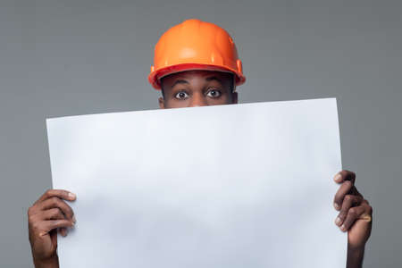 Man in helmet holding paper sheetの写真素材