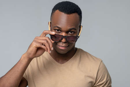Happy man in sunglasses in studioの写真素材