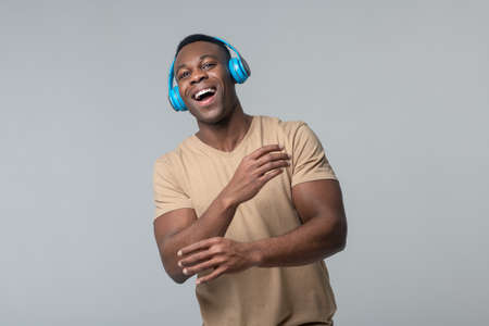 Energetic man in headphones with open mouthの写真素材