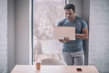 Young businessman working on a laptop and looking involved