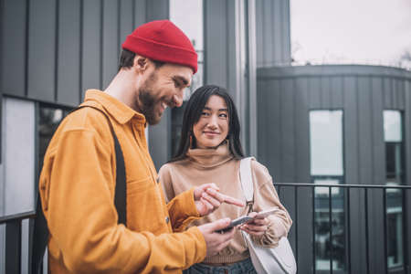 Young couple with smartphones in their handsの写真素材