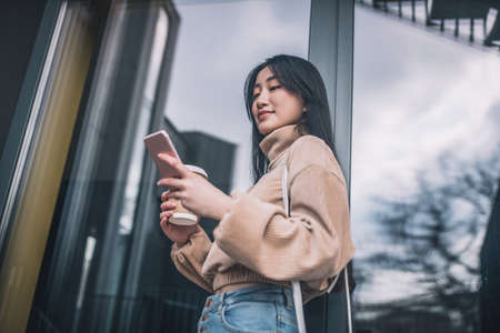 Young modern dark-haired girl outside looking confidentの写真素材