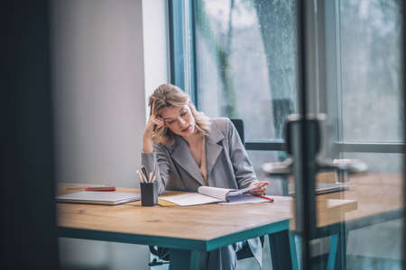 Attentive involved business woman studying documentsの写真素材