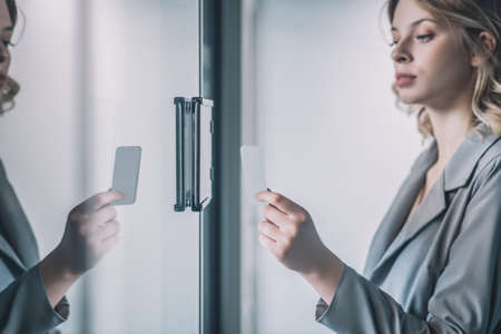 Woman with badge card near office door