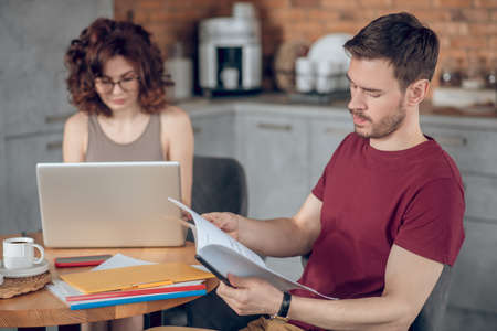 Two people working on project and looking busyの写真素材