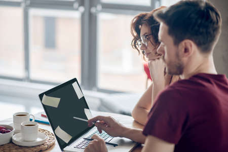 Team members working on a project togetherの写真素材