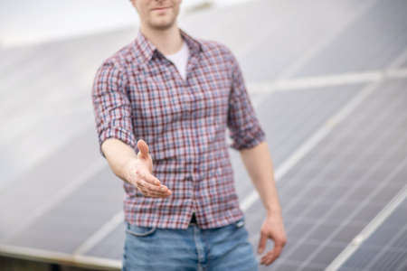 Man extending his hand forward in greetingの写真素材