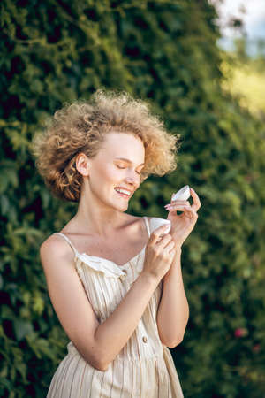Pretty woman holding a jar of organic cream in hands
