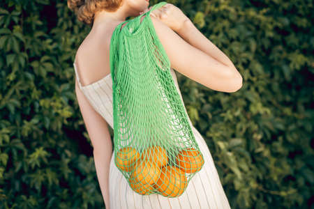Young vegan going home from the shop with fruitsの写真素材