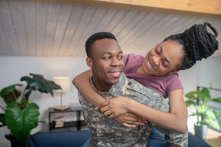 Young military man and wife in cheerful moodの写真素材